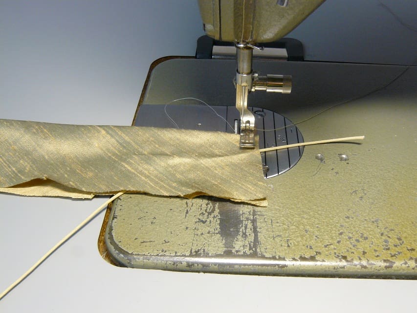Inserting pull cord into bias strip.