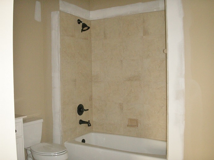Shower and tub area 'before' photo for the shower curtain treatment.