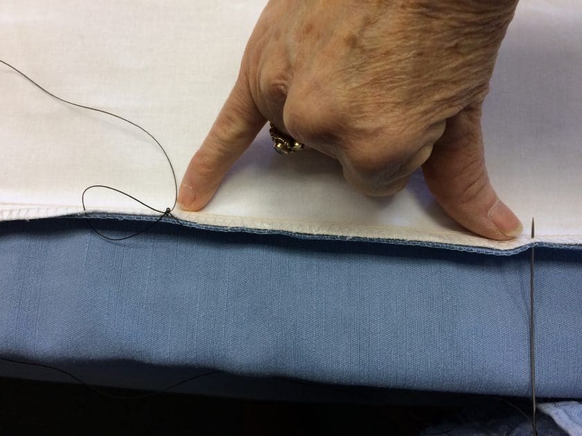 The distance between thumb and pinky for an interlock stitch.