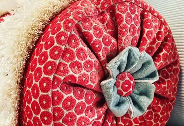 bolster ended with a celtic cross and button