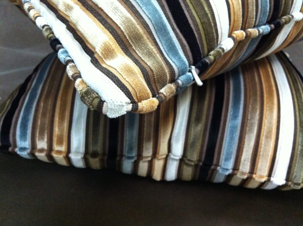 Practice makes perfect, or almost anyway! Once you master the skill of inserting zippers next to welt cord, you'll become comfortable and skilled enough to insert invisible zippers into pillows and match your stripes too. Really you will.