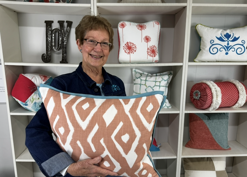 About Us Donna holding a pillow
