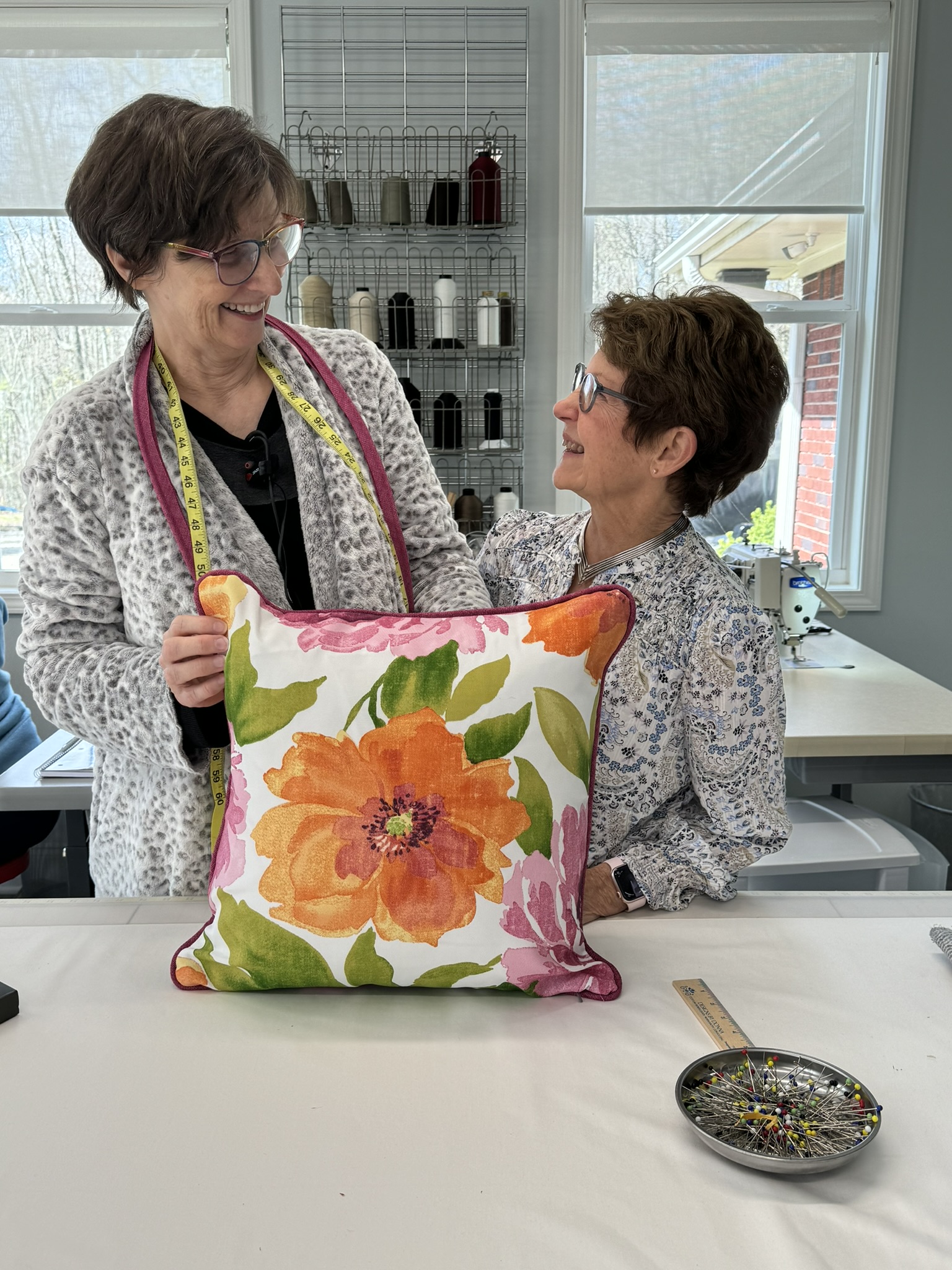 Donna and a happy pillow student-A student holding a finished pillow