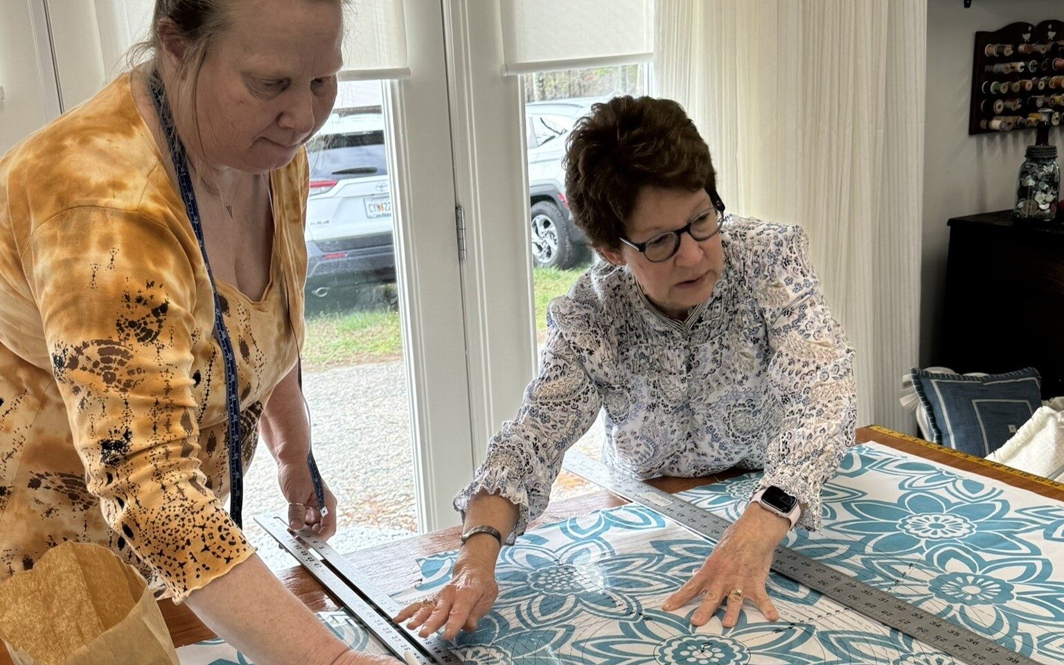 Donna helping with pattern placement – Hands actively sewing, measuring, cutting, or working with fabric