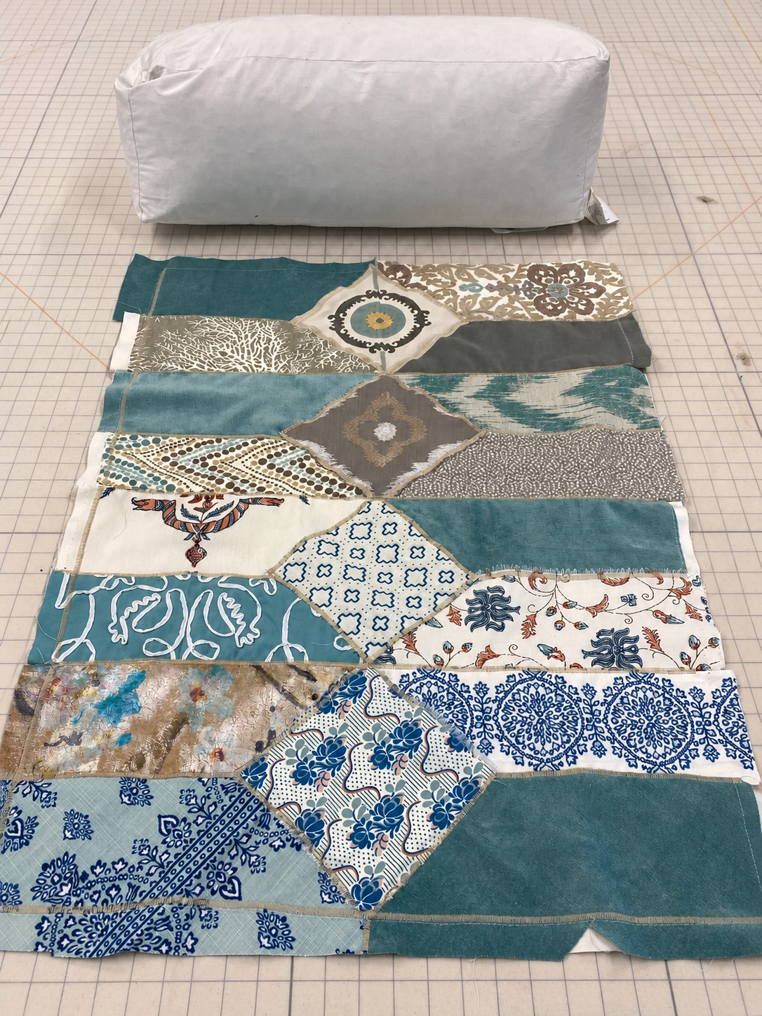 a design in progress-Square bolster with patchwork cover, teal, cream, gray, frilly ends